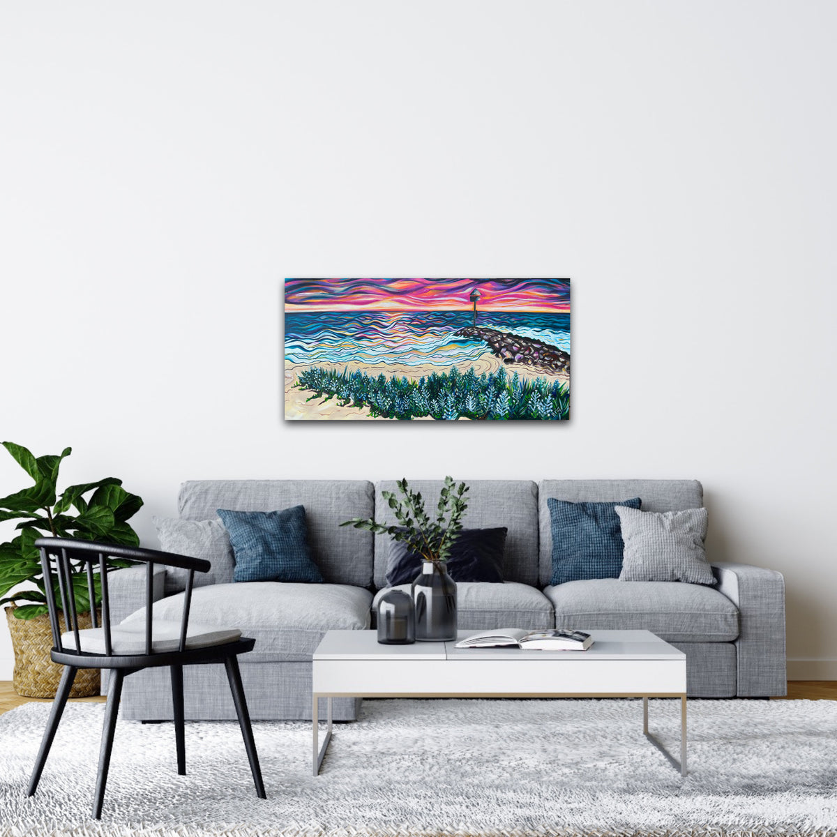 Room mock-up of City Beach at Sunset above a grey sofa with blue cushions.