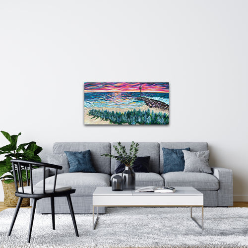 Room mock-up of City Beach at Sunset above a grey sofa with blue cushions.