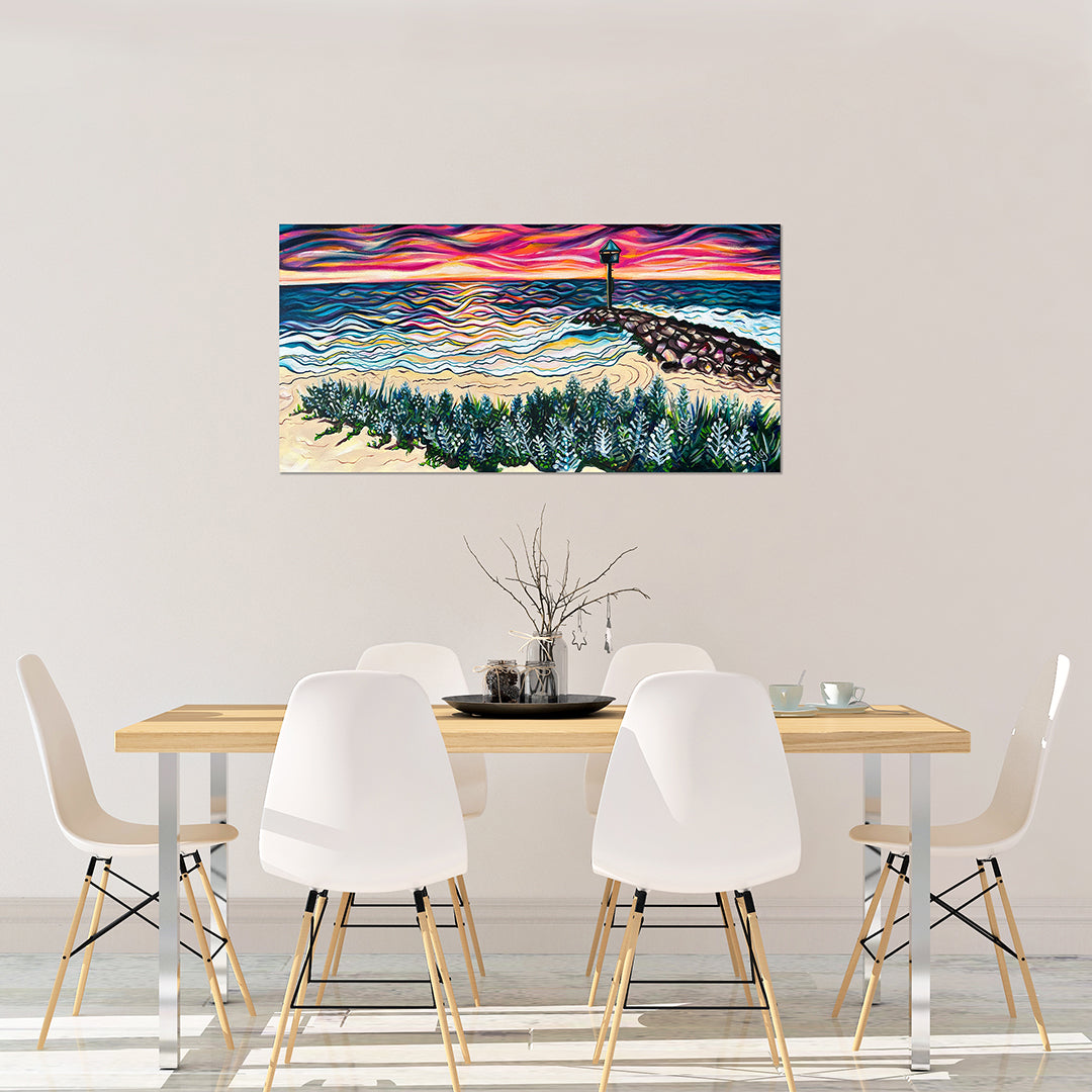 Room mock-up of City Beach at Sunset above a wooden dining table with white chairs.