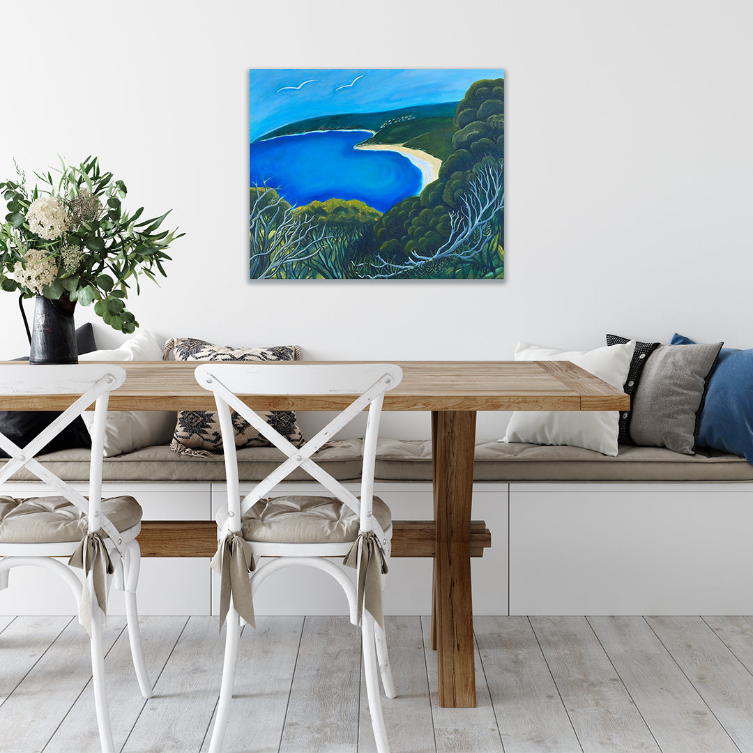 Room mock-up of Down South Somewhere by Brigitte James above a wooden dining table with white chairs.