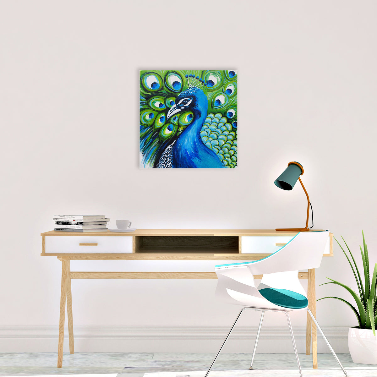 Brigitte James’s original blue and green Peacock acrylic painting on canvas, displayed above a wooden desk with a white chair and teal lamp.