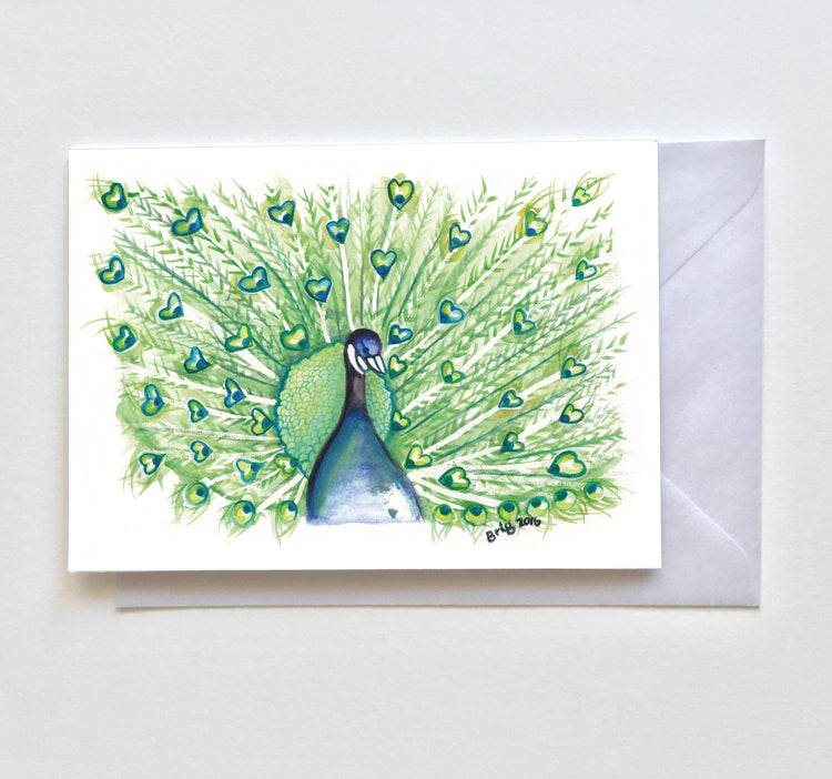Peacock Watercolour with Hearts greeting card by Brigitte James, shown with an envelope behind it.